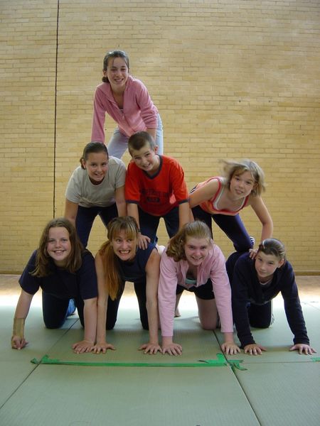Acro pyramid young people in a gym